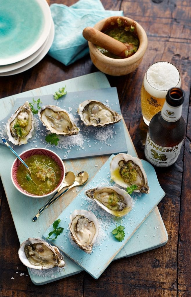 Oysters served with nam jim sauce and Singha Beer.