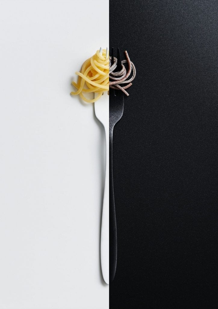 Black and white spaghetti on a fork