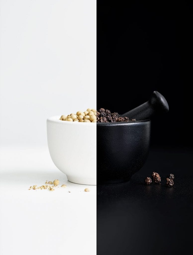 Black and white pepper with a pestle and mortar